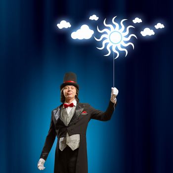 Image of man magician with balloon against color background