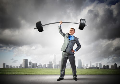 Image of strong businessman lifting barbell above head with one hand