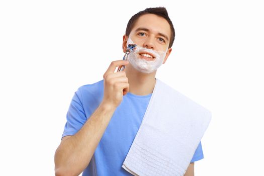 Young man at home shaving himself in the morning