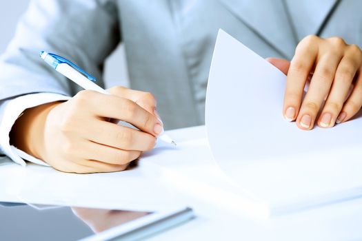 Close up image of businesswoman hands signing documents