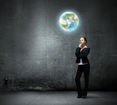 Image of thoughtful businesswoman looking at planet earth