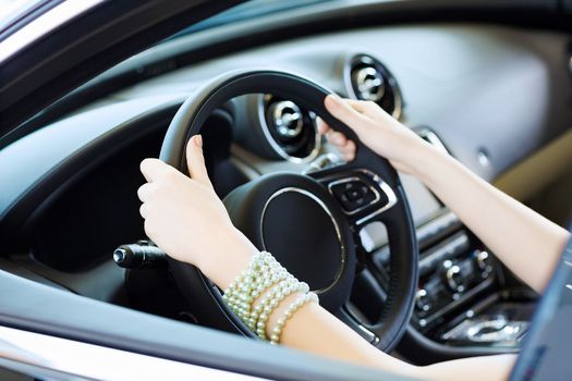 Close up of woman hands driving a car