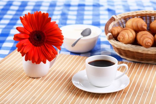 Continental breakfast with croisant and black coffee