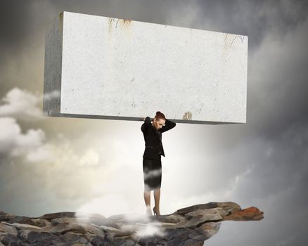 Image of businesswoman holding stone on her shoulders