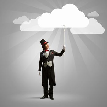 Image of wizard in hat catching clouds