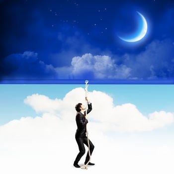 Image of businessman pulling banner with illustration. Day and night concept