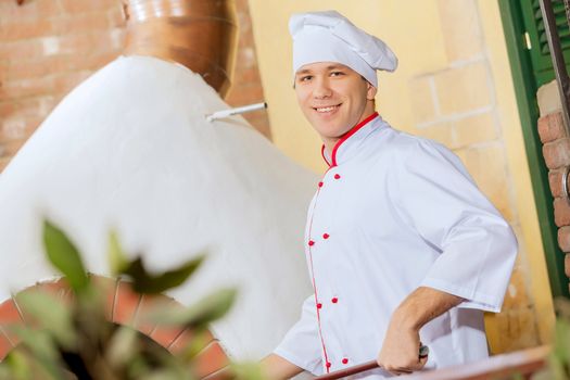 Image of young handsome male cook at kitchen
