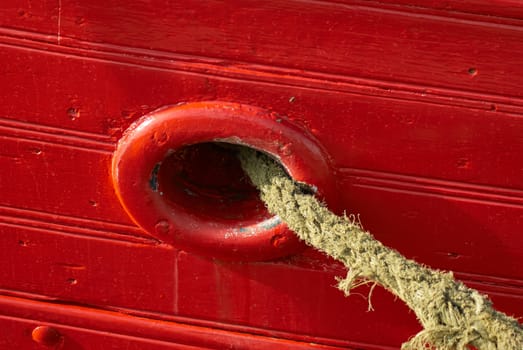 Old ship anchor rope with strong red color boating background