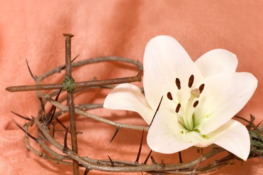 Crown of Thorns, crucifix and Easter white Lily on  Beige background