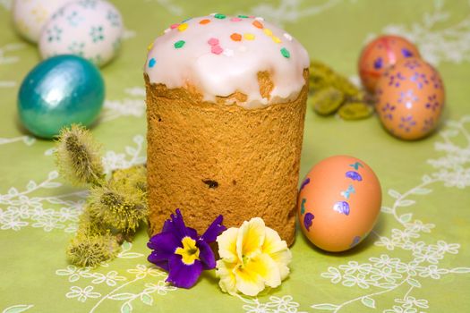 Easter cake with glace icing and colored easter eggs 