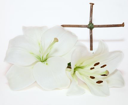 metal  crucifix and Easter white Lily  on  white background