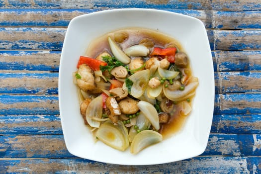 fried   vegetables with fish on white plate on the table