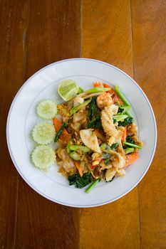 thai noodle with seafood on white plate on the table