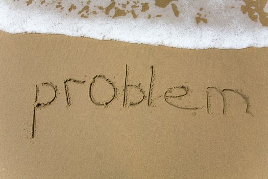 Handwriting word problem  written  in the sand