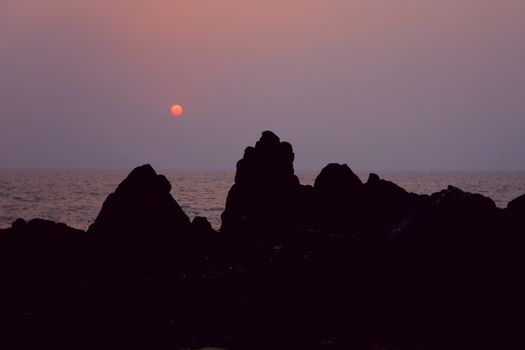black mountain at sunset  in Arambol, Goa, India