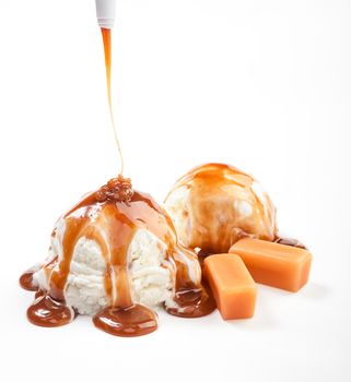 Two icecream balls under the caramel topping