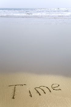 Handwriting word Time written  in the sand