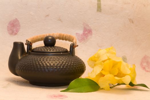 asian style - Yellow iris and black teapot 