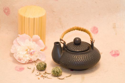 Black teapot with Lotus Flower Chinese tea and flower of peony
