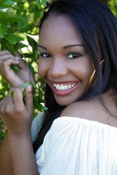 A close-up of a lovely young Haitian girl outdoors, with a captivating smile.