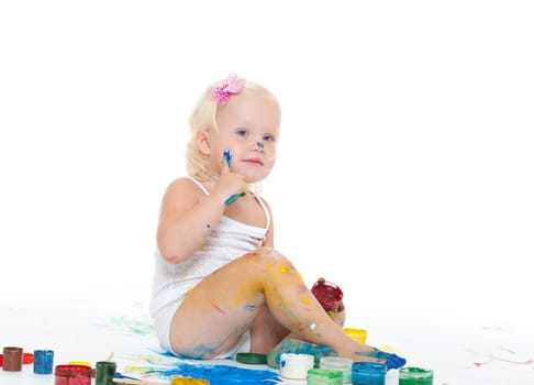 Little girl bedaubed with bright colors