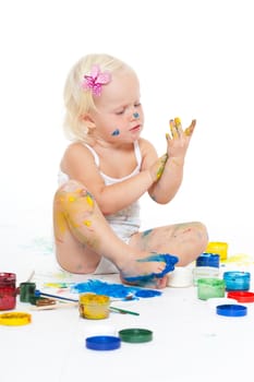 Little girl bedaubed with bright colors