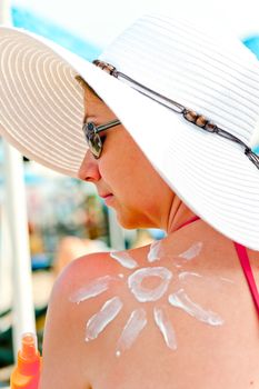 sun on the shoulder of a young girl painted sunscreen