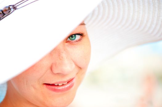 close-up portrait of a young charming smiling girl in a hat