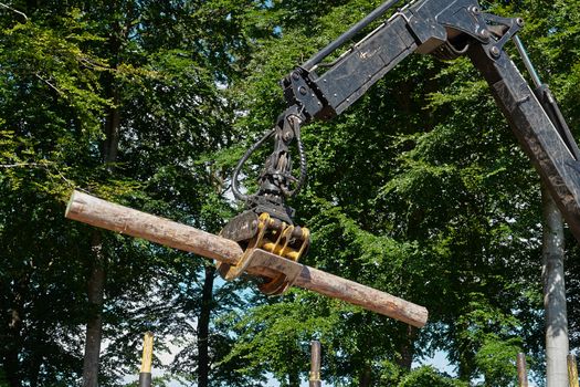 Heavy harvester loader truck doing forestry work in the forest with logs