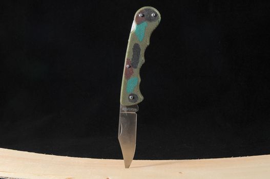 A Mimetic Hunting Knife on a Black Background