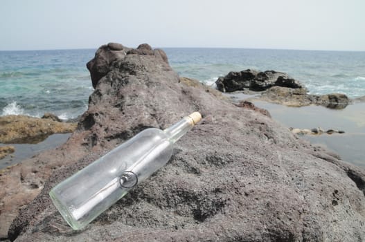 Message in the Bottle on the Rocks near the Beach