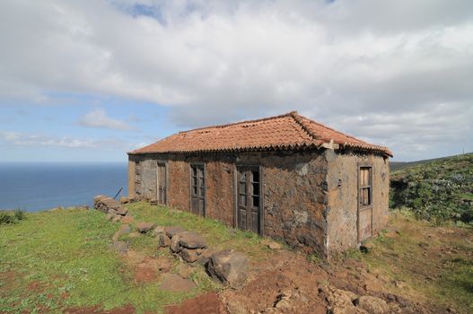 Brown Ancient Rural House on a Cloudy Sky