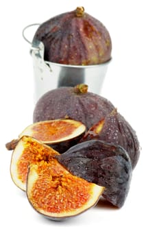 Arrangement of Ripe Figs Full Body and Slices in Tin Bucket isolated on white background