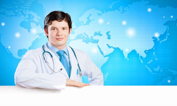 Image of handsome doctor holding white blank banner