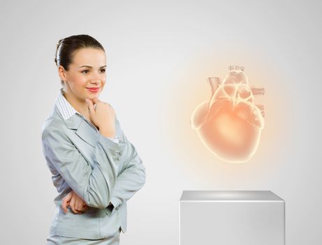 Image of businesswoman looking at icon. Health care