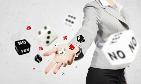 Close-up image of businesswoman throwing dices. Gambling concept