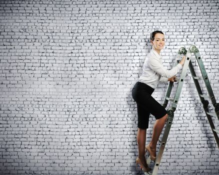 Image of young ambitious businesswoman climbing ladder. Promotion concept