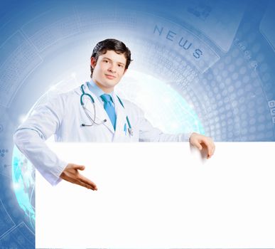 Image of handsome doctor holding white blank banner