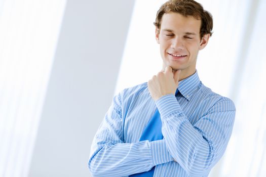 Image of young handsome confident businessman in suit