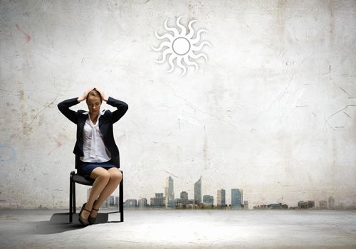 Image of depressed businesswoman sitting on chair
