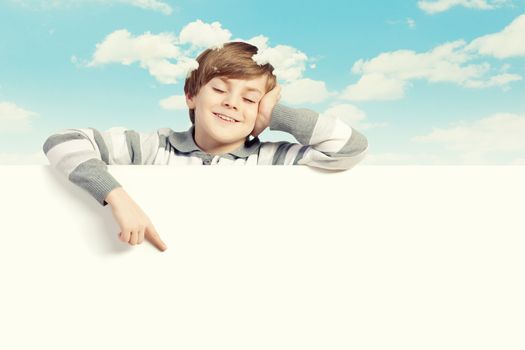 Little boy holding a blank white billboard