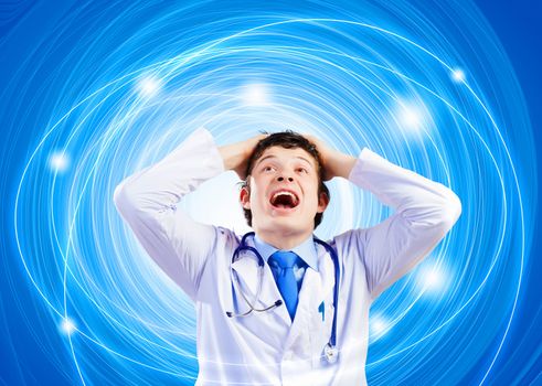 Image of young male doctor screaming in madness
