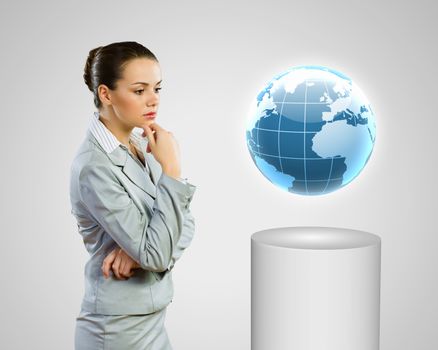 Image of thoughtful businesswoman looking at globe
