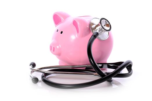 Piggy bank with stethoscope isolated on white concept for financial checkup or saving for medical insurance costs 