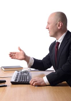 profile of a businessman at desk with hand out gesturing a hand shake isolated on white