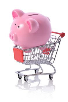 Concept of savings on shopping, piggy bank in a shopping trolly isolated on white