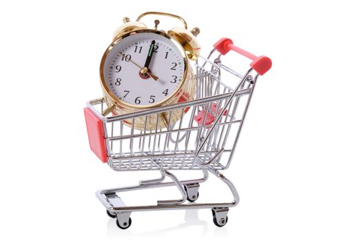 Time is money concept of clock in a shopping trolley isolated on white