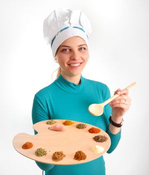 Spices and herbs on the palette and cook girl shoot in studio