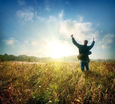 Man in the field at sunrise in autumn