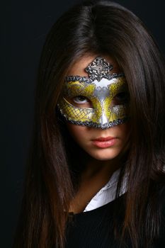 The young beautiful girl in mask looks at you